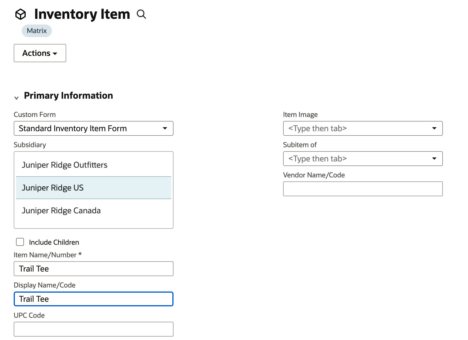 A new Inventory Item form with a Matrix tag under the title and an Actions button. Subsidiary has Juniper Ridge US selected. Item Name/Number and Display Name/Code both read Trail Tee.
