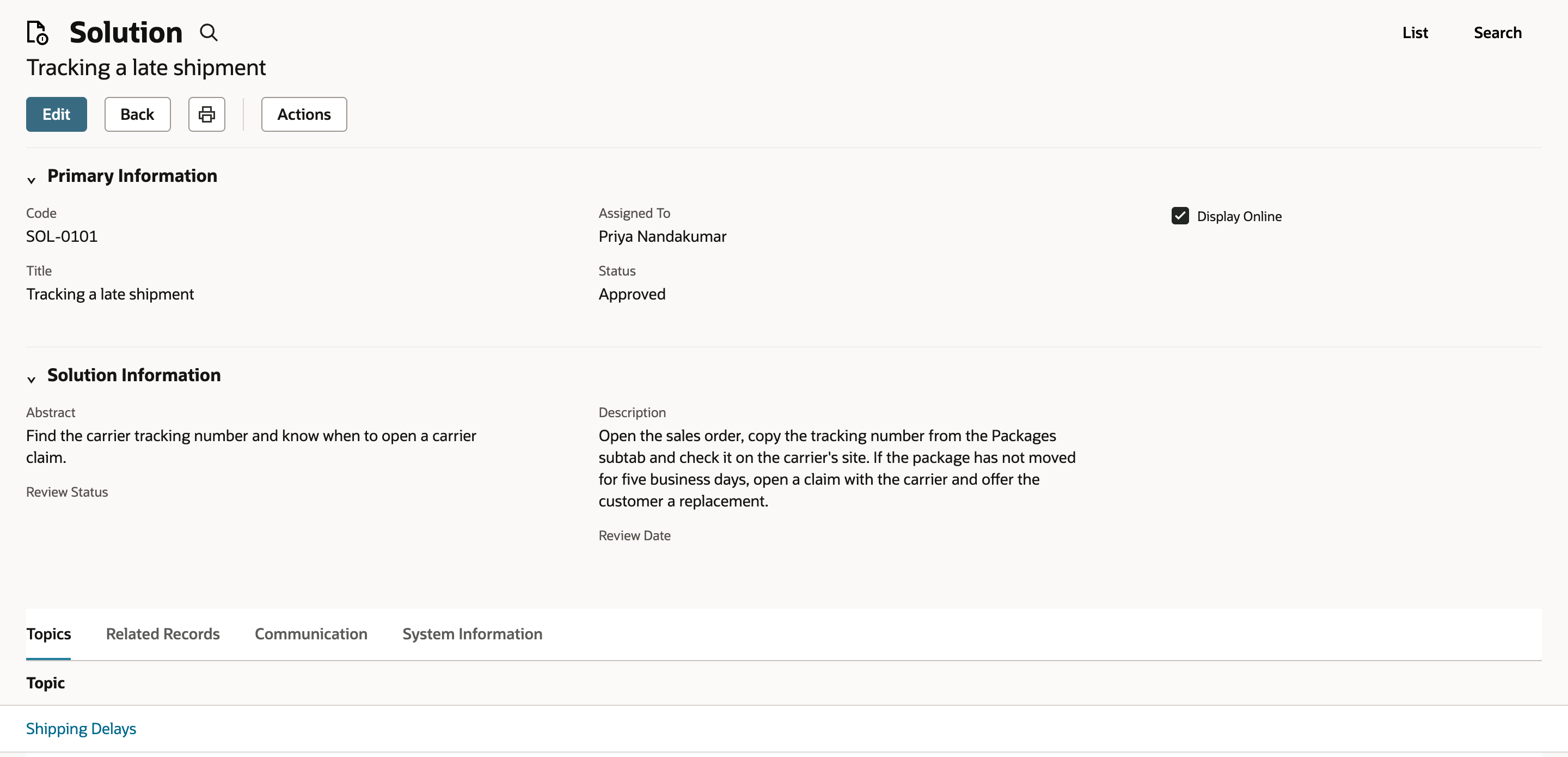 Solution SOL-0101 Tracking a late shipment with Status Approved, Display Online checked, its abstract and description, and Shipping Delays on the Topics subtab.